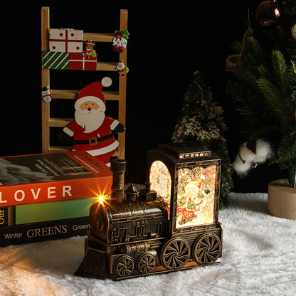 Decorative metallic train lamp with Christmas-themed items including a Santa figure and gift box.