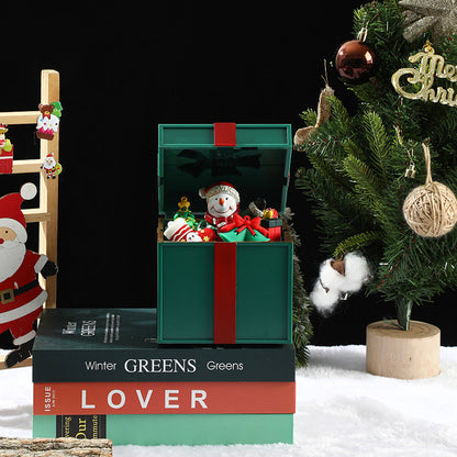 Decorative Christmas scene with a snowman in a box, Santa Claus figure, and Christmas tree.