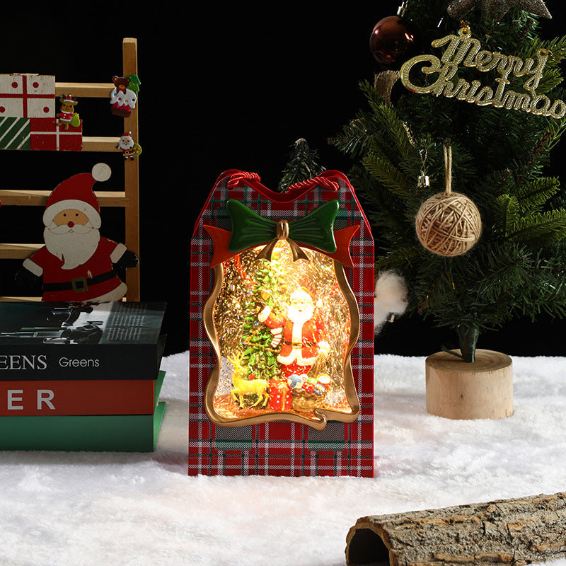 Decorative Christmas scene with a lit-up ornament, tree, and Santa Claus figure.