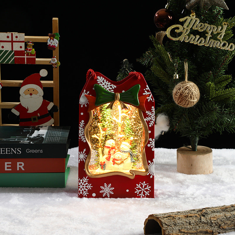 Decorative Christmas light box with a snow globe design, surrounded by festive items.