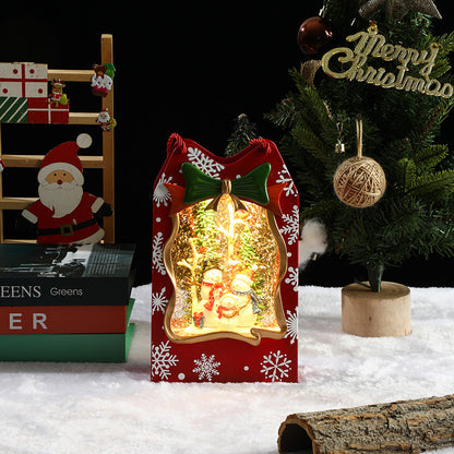 Decorative Christmas light box with a snow globe design, surrounded by festive items.