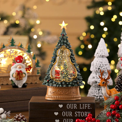 Decorative Christmas tree figurine with lights and Santa Claus, surrounded by festive decorations.