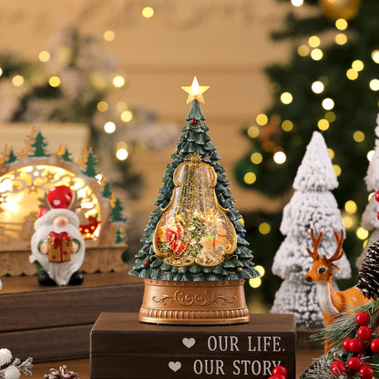 Decorative Christmas tree with lights and ornaments on a wooden base, surrounded by festive decorations.